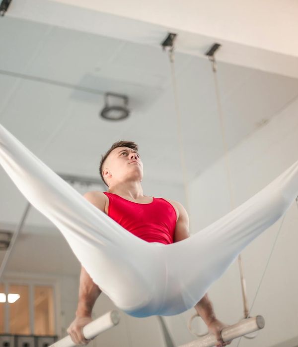 Man performing a strength exercise in a dark, focused environment.